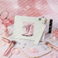 White canvas custom makeup case with Let's Go Girls design surrounded by feminine makeup items, rose petals and sparkles